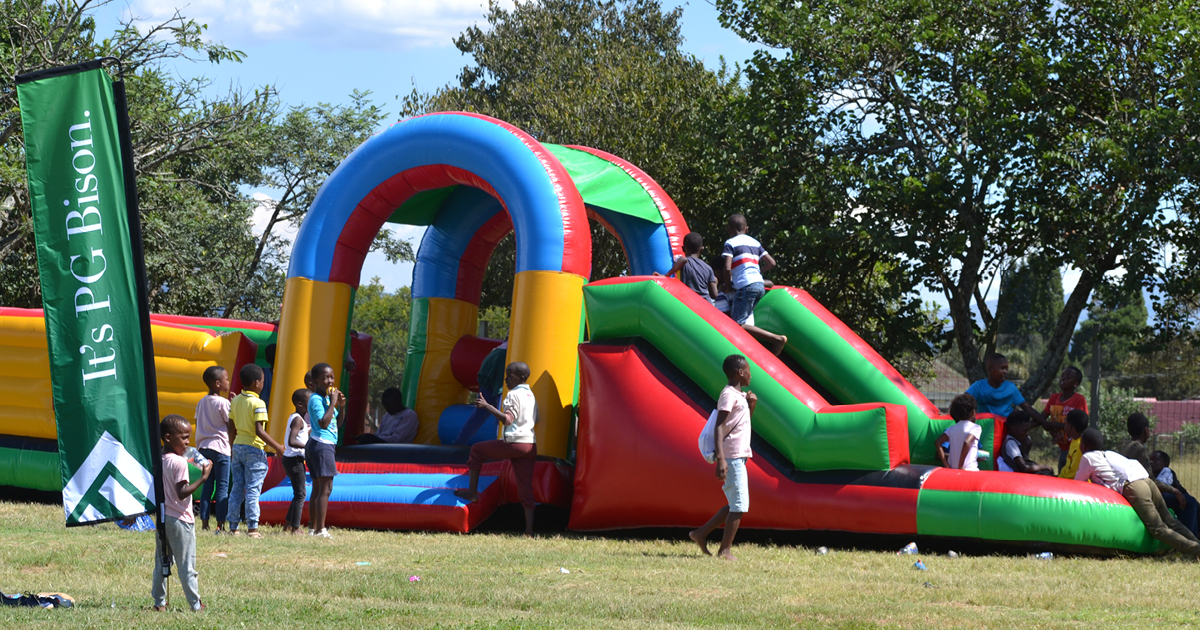 childern playing at a PG Bison event on jumping castle